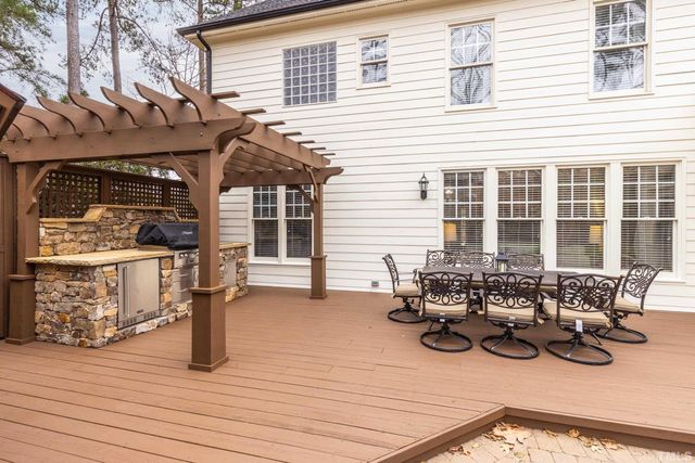 a view of a patio with table and chairs and wooden floor
