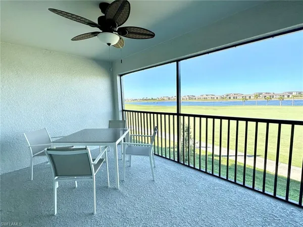 a dining room with furniture and a mirror