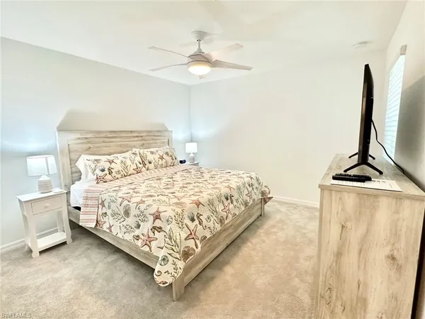 a bedroom with a bed and a flat screen tv in it