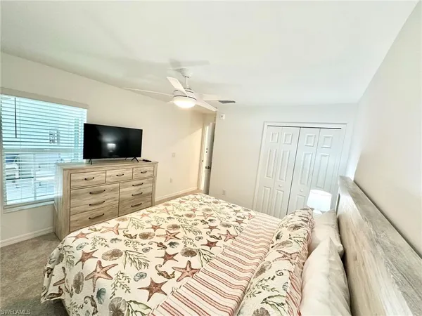 a bathroom with a granite countertop sink a toilet and a large mirror