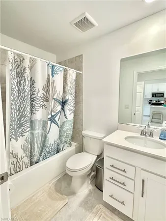 a living room with furniture and a chair