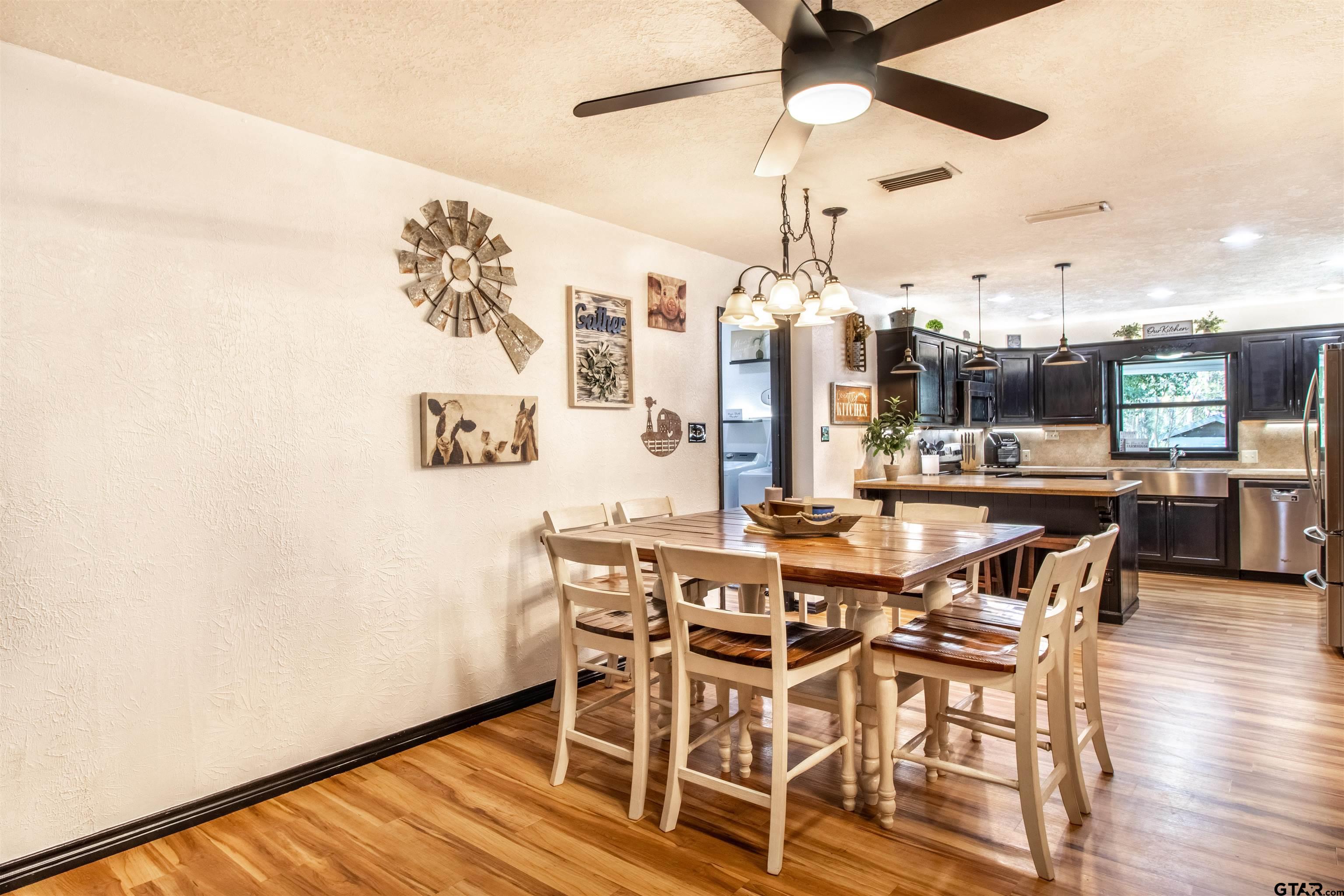 513 Lance Road Quitman, TX 75783 - Photo 6 of 27 a view of a dining room with furniture and wooden floor