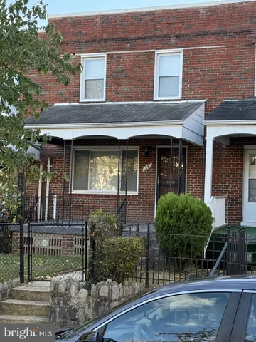 a view of brick building with a tree in front
