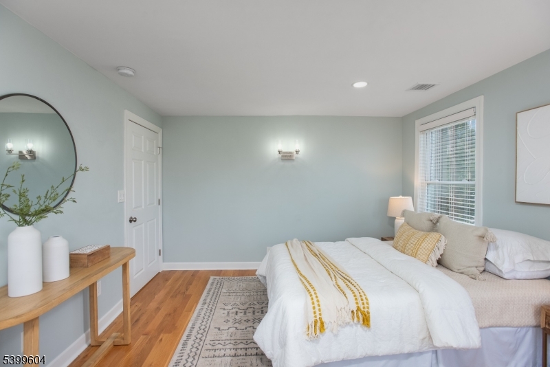 122 North Fullerton Avenue, Unit 2 Montclair, NJ 07042 - Photo 13 of 23 a bedroom with a bed and a mirror