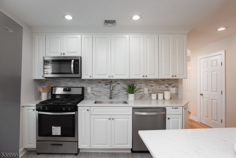 122 North Fullerton Avenue, Unit 2 Montclair, NJ 07042 - Photo 10 of 23 a kitchen with granite countertop white cabinets and stainless steel appliances