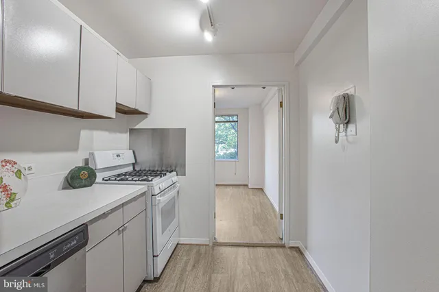 a kitchen with a sink a stove and cabinets
