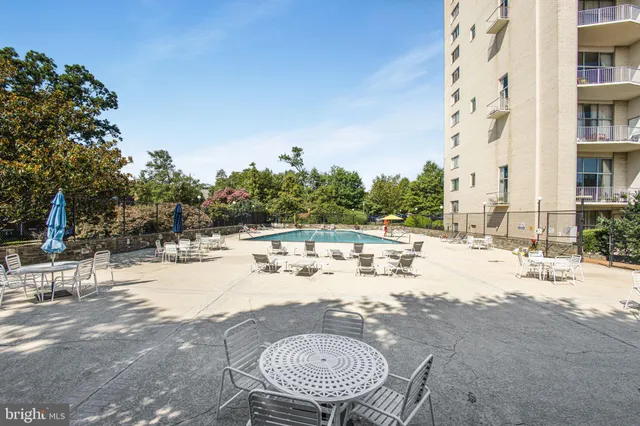 a view of a swimming pool with outdoor seating
