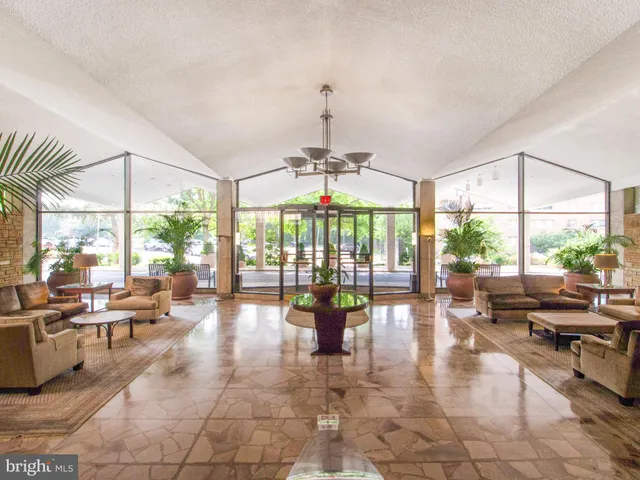 a lobby with furniture and large windows