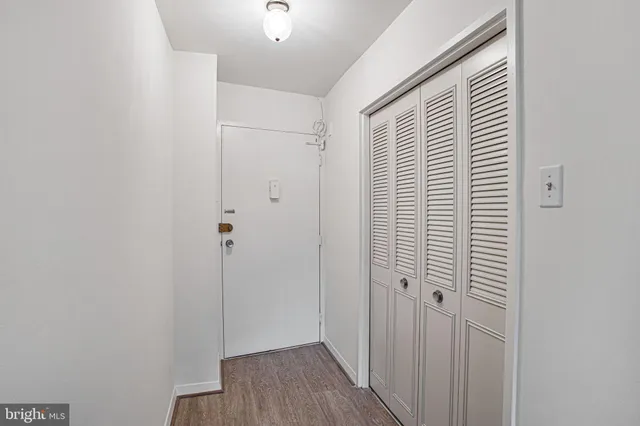 a view of a hallway with wooden floor