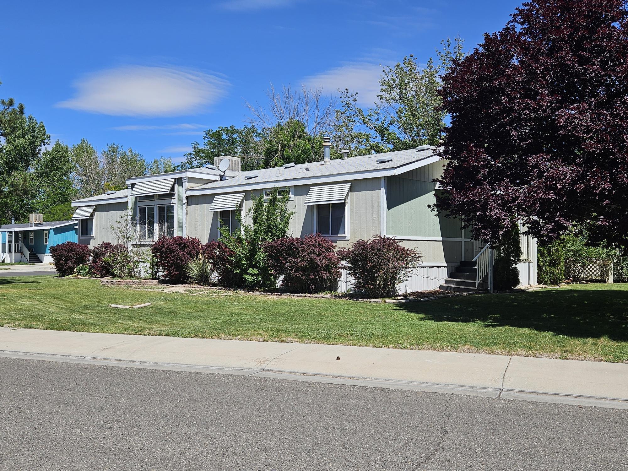 435 32 Road, Unit 424 Clifton, CO 81520 - Photo 4 of 21 a front view of house with yard and green space