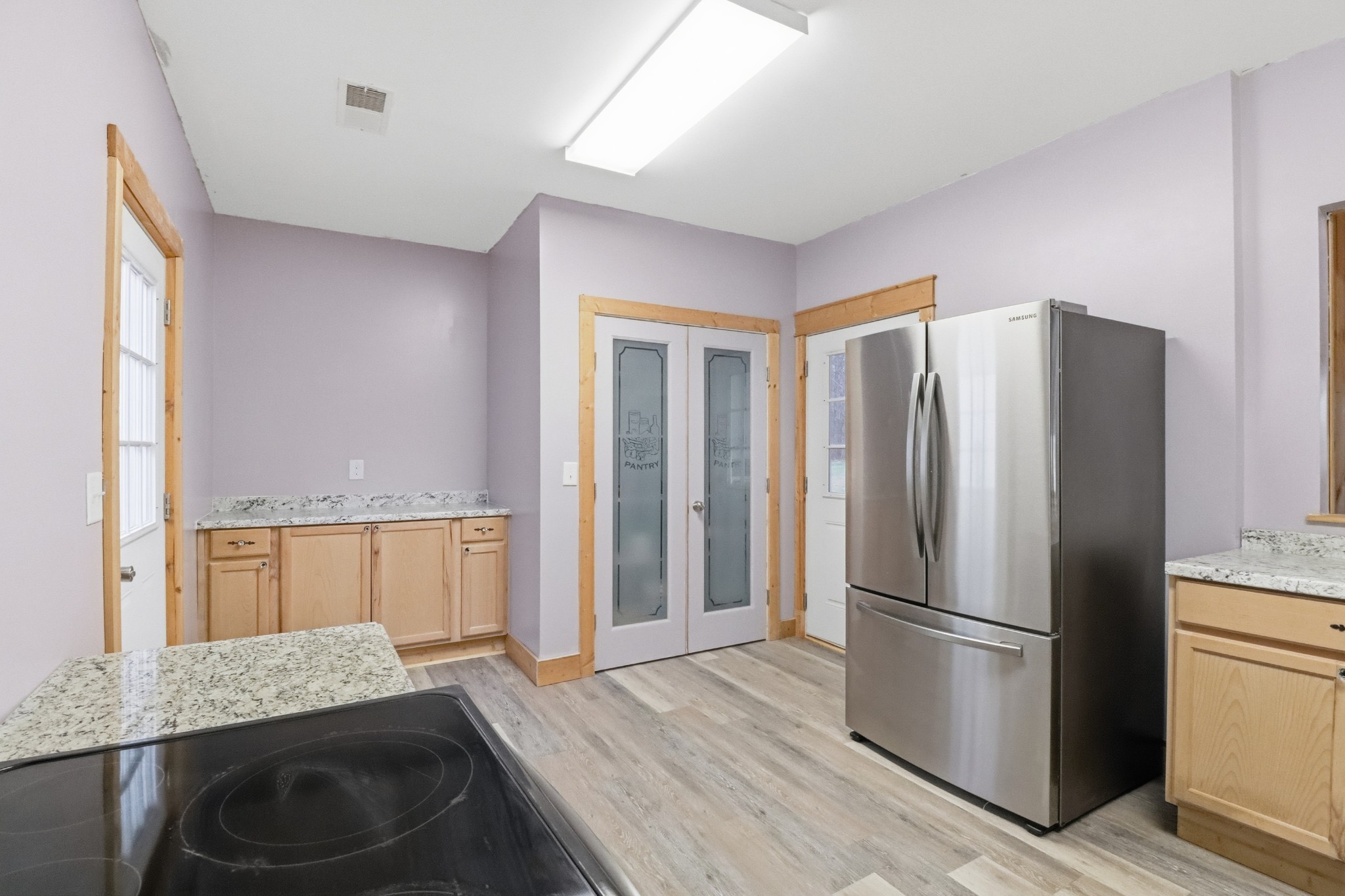 3287 Bluebird Road Lebanon, TN 37087 - Photo 55 of 64 a kitchen with granite countertop a refrigerator and a stove top oven