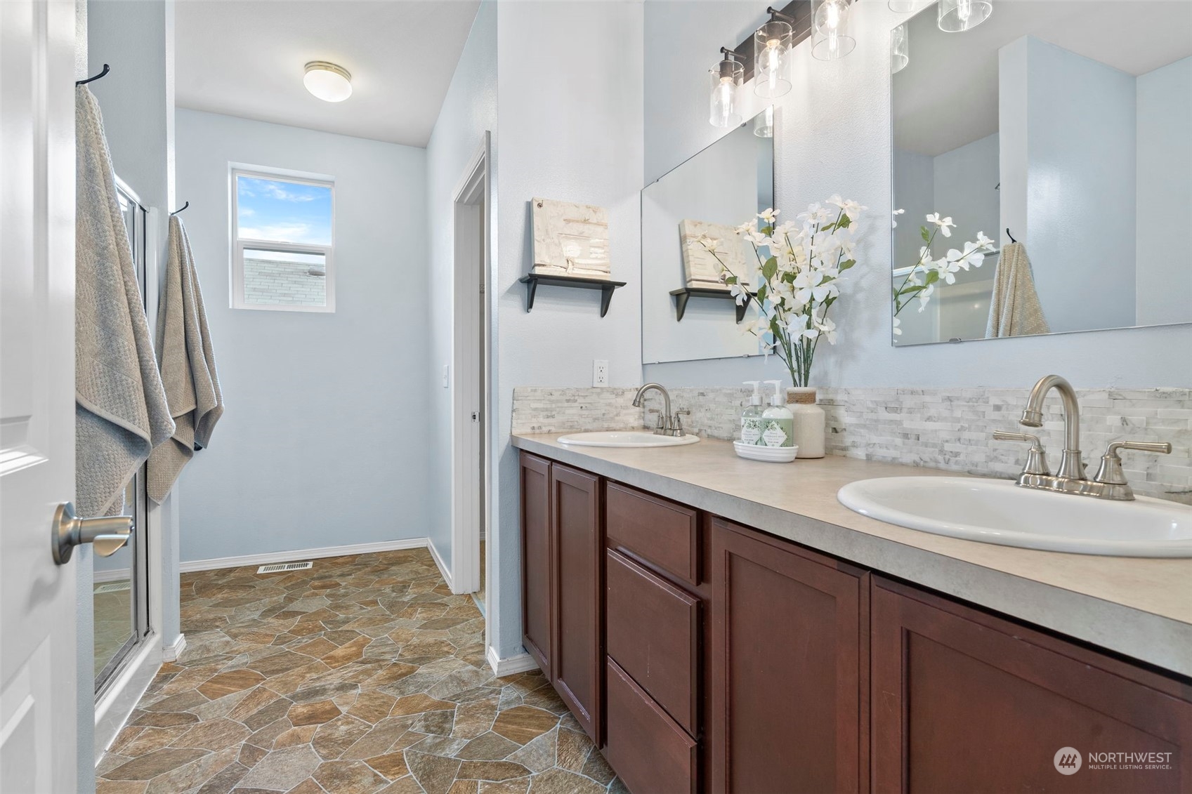 9175 Periwinkle Loop Northeast Lacey, WA 98516 - Photo 14 of 29 a bathroom with a sink a vanity and a mirror