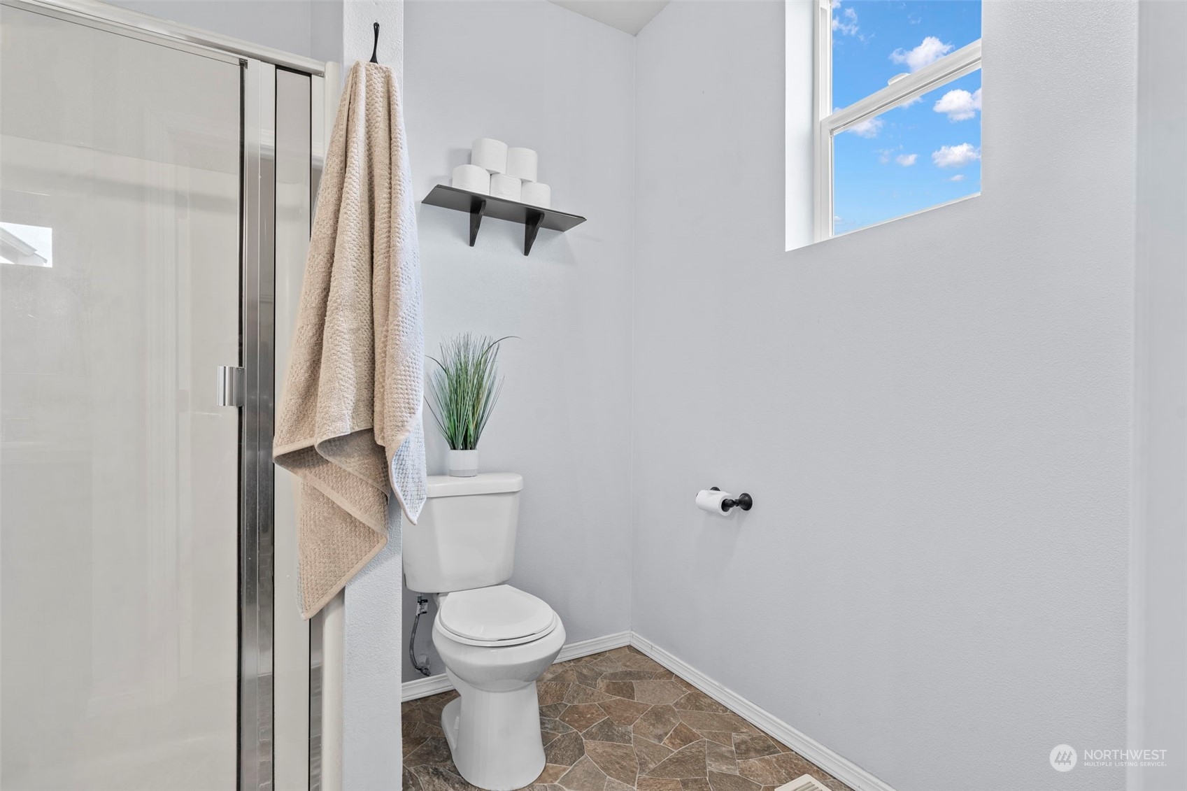 9175 Periwinkle Loop Northeast Lacey, WA 98516 - Photo 15 of 29 a white toilet sitting next to a shower curtain