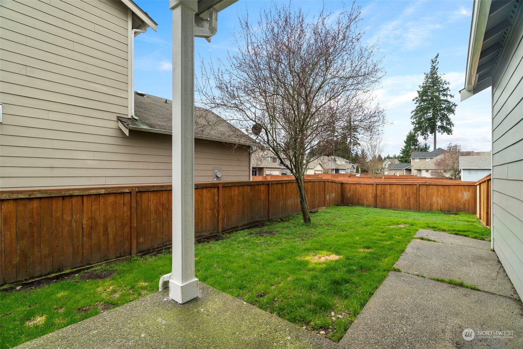 9175 Periwinkle Loop Northeast Lacey, WA 98516 - Photo 23 of 29 a view of a backyard with potted plants and wooden fence