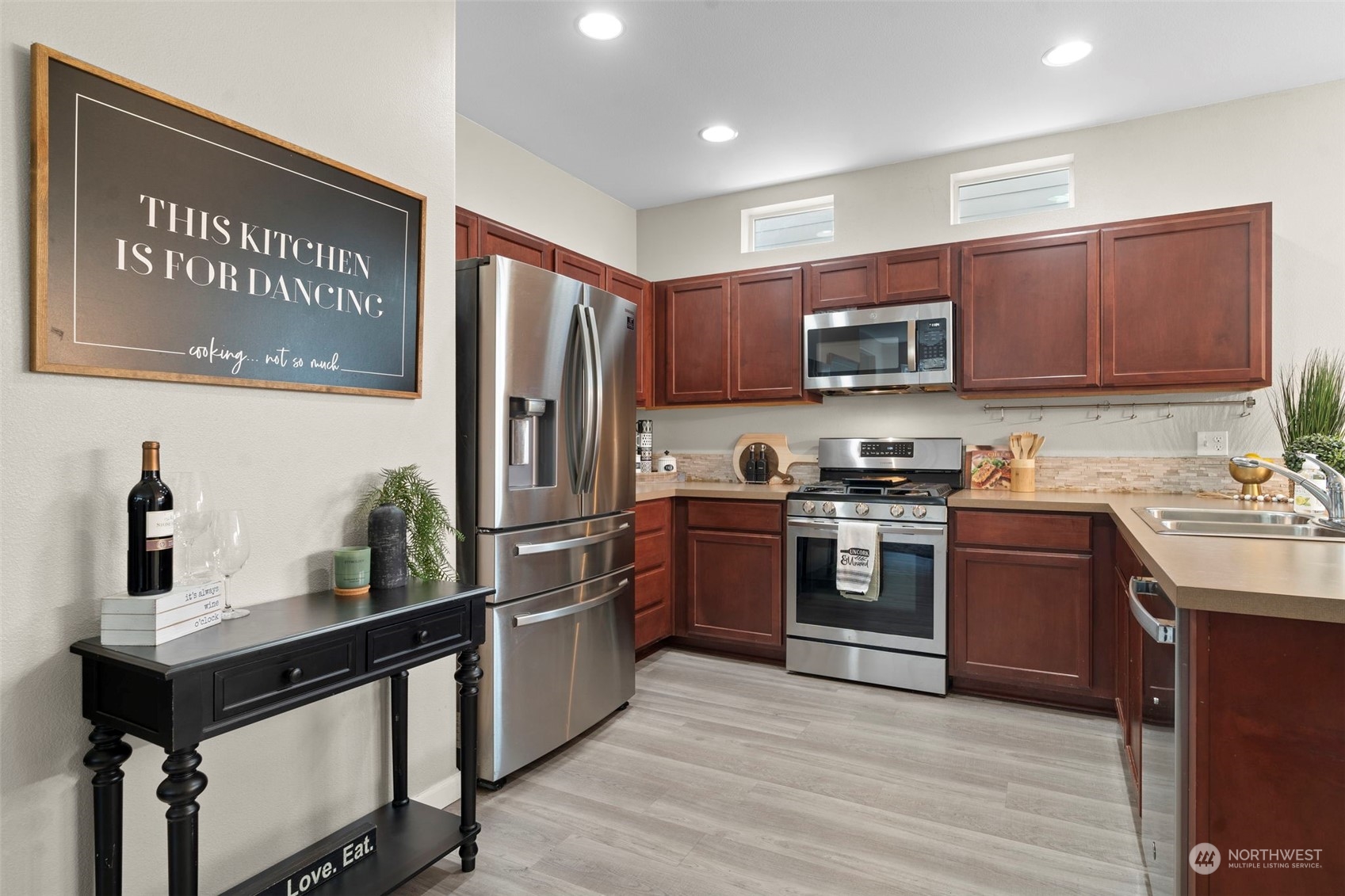 9175 Periwinkle Loop Northeast Lacey, WA 98516 - Photo 6 of 29 a kitchen with stainless steel appliances granite countertop a stove refrigerator and a microwave