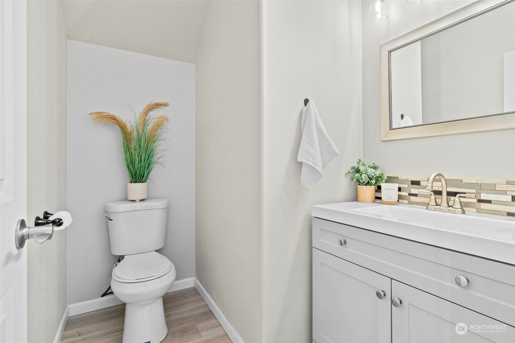 9175 Periwinkle Loop Northeast Lacey, WA 98516 - Photo 9 of 29 a bathroom with a sink a toilet and a mirror