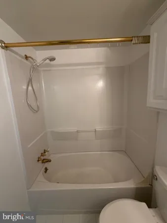 a bathroom with a shower and a toilet