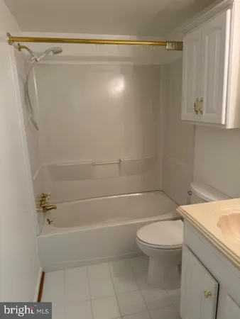 a bathroom with a shower a toilet and a sink