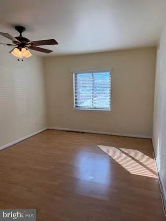 a view of a room with wooden floor and a window