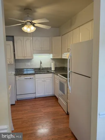 a kitchen with a white cabinets and white appliances