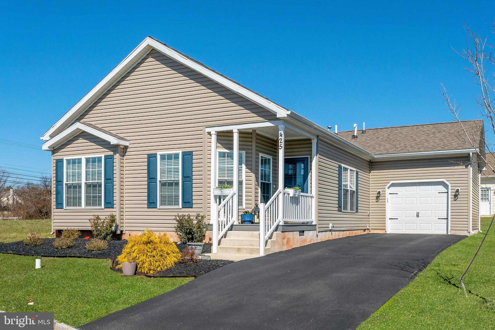 a front view of a house with a garden and porch
