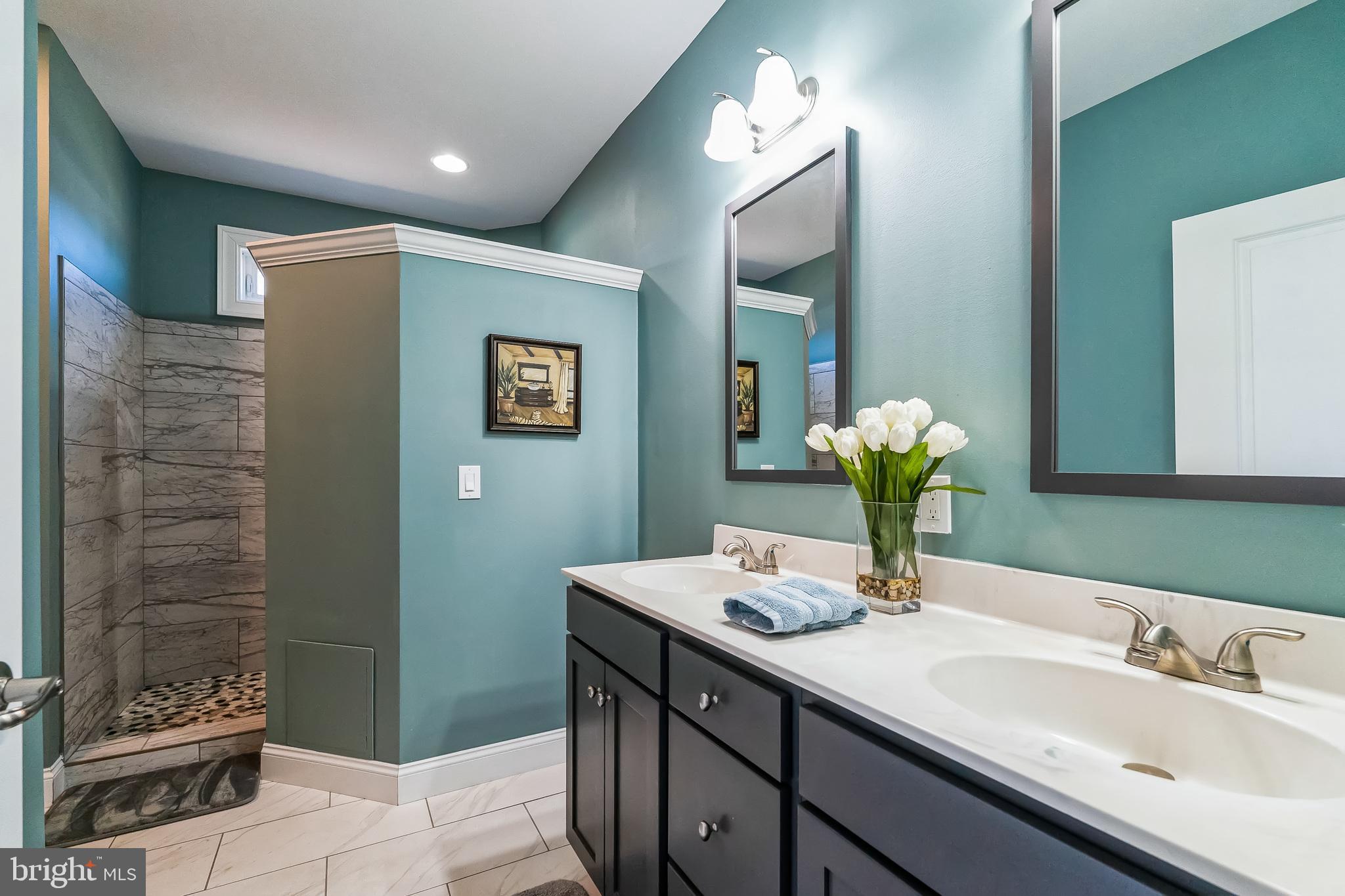 425 Azalea Drive Blue Bell, PA 19422 - Photo 17 of 26 a bathroom with a granite countertop sink a toilet and mirror