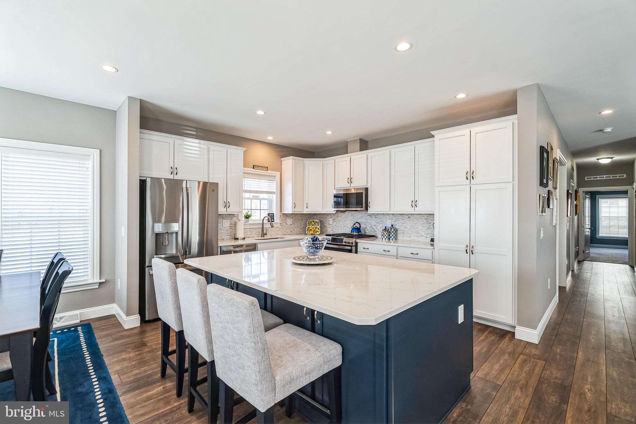 425 Azalea Drive Blue Bell, PA 19422 - Photo 6 of 26 a kitchen with refrigerator cabinets dining table and chairs