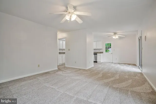 a view of an empty room with a ceiling fan