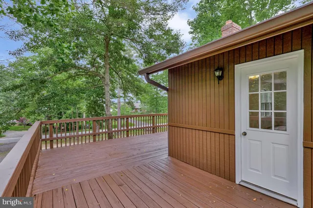 a view of backyard with deck and wooden floor
