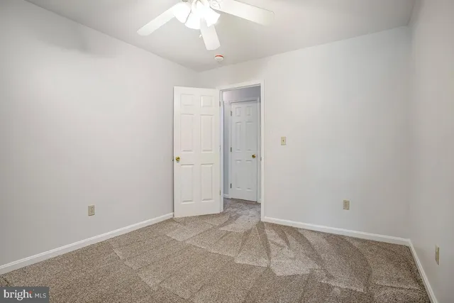 an empty room with a empty space and a ceiling fan