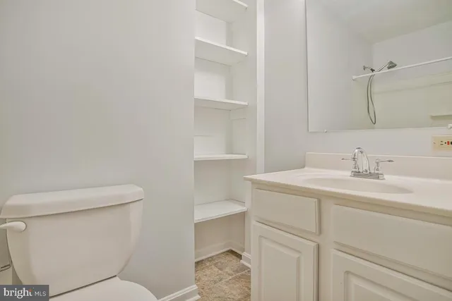 a bathroom with a sink toilet vanity and tub
