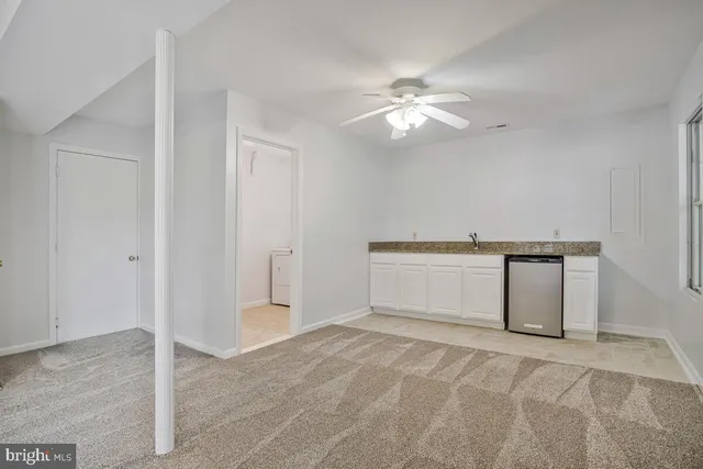 a view of a kitchen with cabinet and a ceiling fan