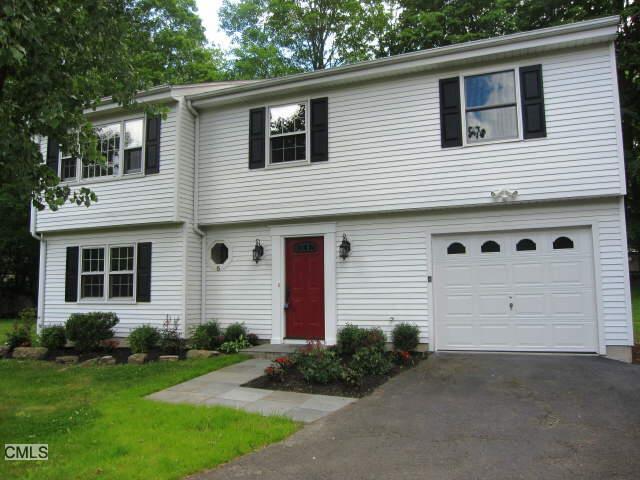 5 Crest Road Ridgefield, CT 06877 - Photo 1 of 1 a front view of a house with a yard and garage