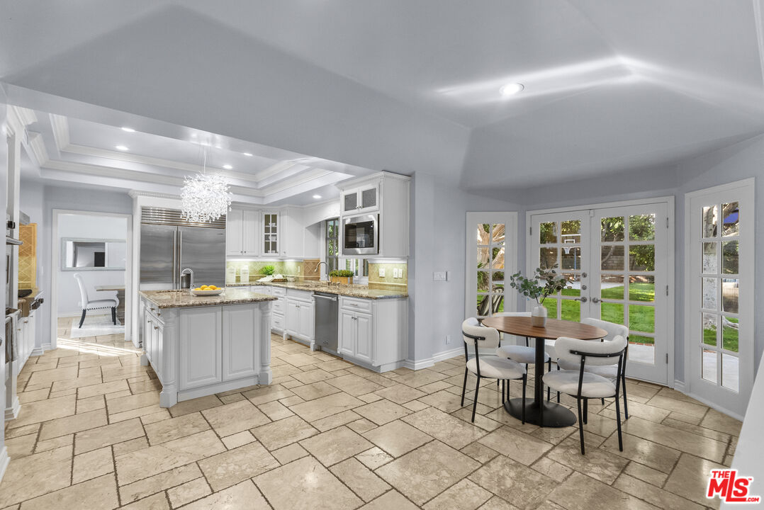 18779 Willowtree Lane Porter Ranch, CA 91326 - Photo 11 of 63 a kitchen with a sink and chairs