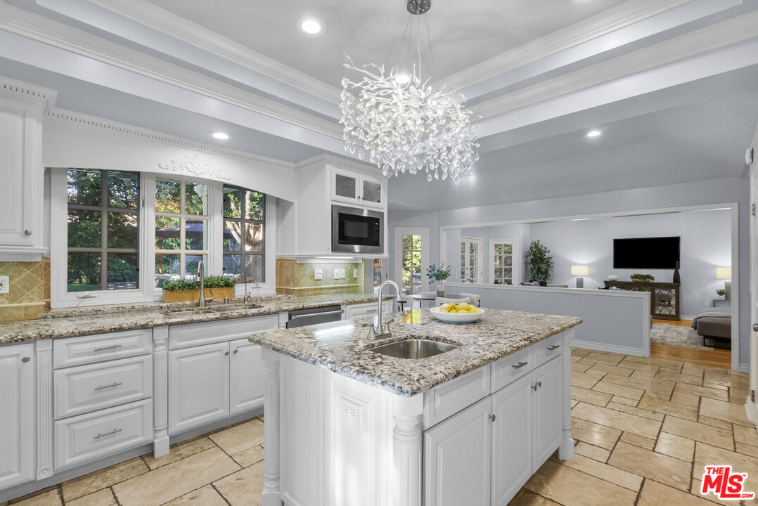 18779 Willowtree Lane Porter Ranch, CA 91326 - Photo 20 of 63 a kitchen with a sink stove and cabinets