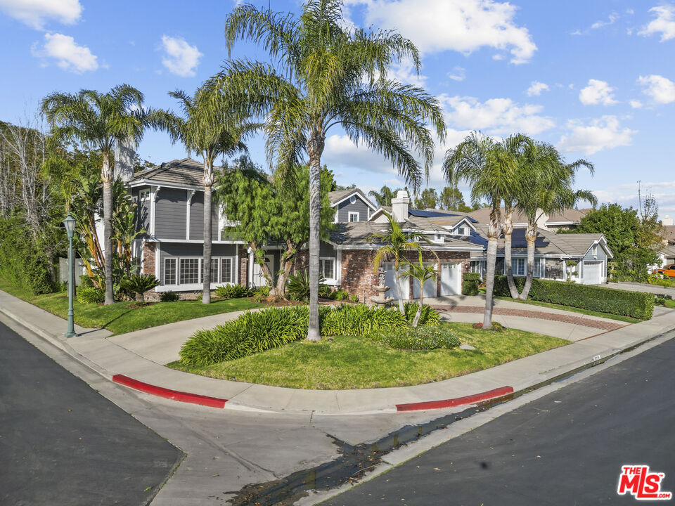 18779 Willowtree Lane Porter Ranch, CA 91326 - Photo 2 of 63 a view of swimming pool with a yard and palm trees