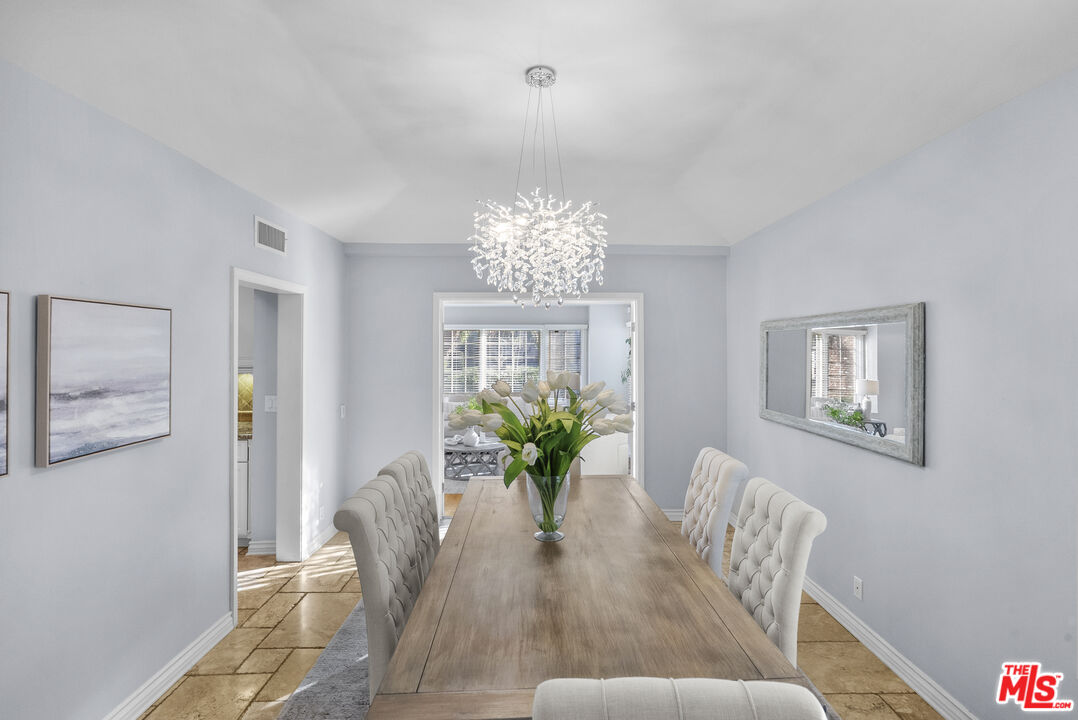 18779 Willowtree Lane Porter Ranch, CA 91326 - Photo 22 of 63 a view of a dining room with furniture a chandelier and wooden floor