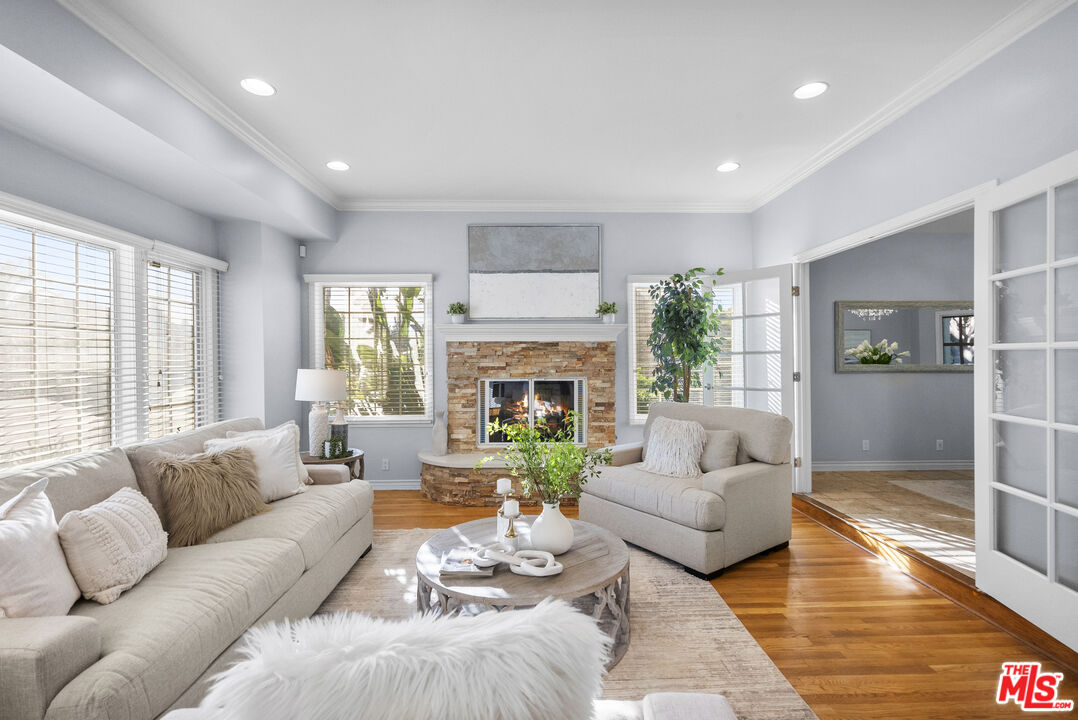 18779 Willowtree Lane Porter Ranch, CA 91326 - Photo 24 of 63 a living room with furniture fireplace and a large window
