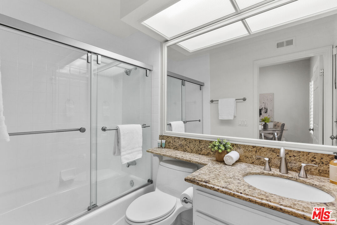 18779 Willowtree Lane Porter Ranch, CA 91326 - Photo 30 of 63 a bathroom with a granite countertop sink toilet and shower