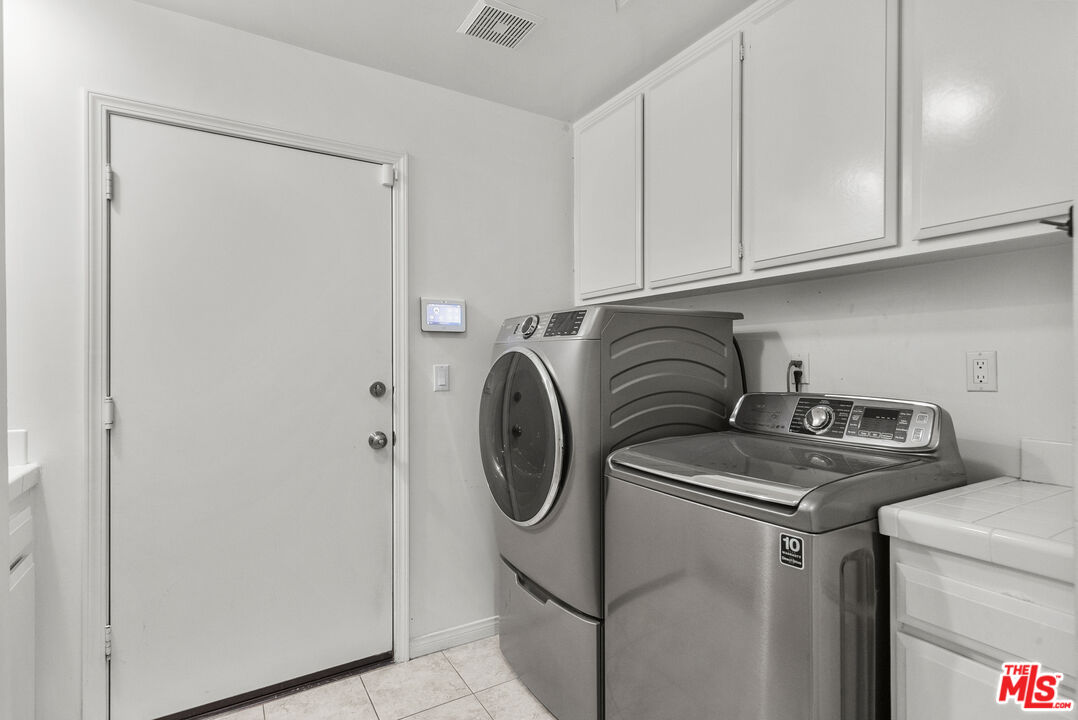 18779 Willowtree Lane Porter Ranch, CA 91326 - Photo 31 of 63 a utility room with dryer and washer