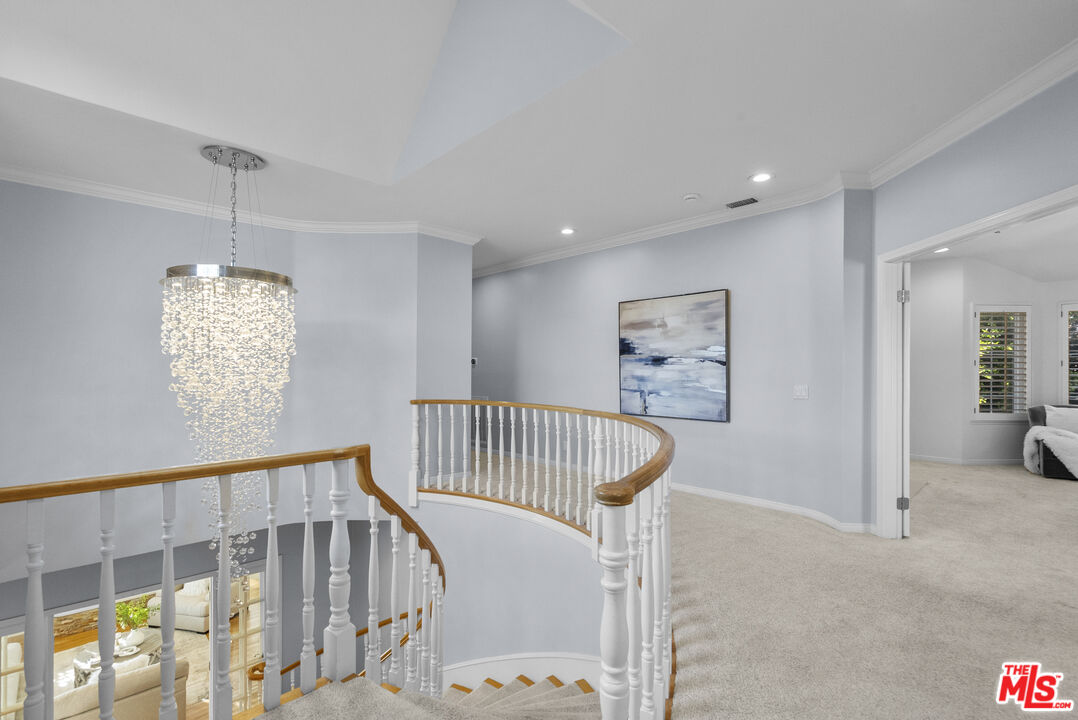 18779 Willowtree Lane Porter Ranch, CA 91326 - Photo 32 of 63 a view of staircase with furniture and chandelier
