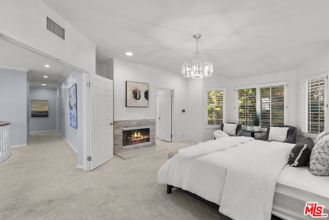 18779 Willowtree Lane Porter Ranch, CA 91326 - Photo 35 of 63 a spacious bedroom with a bed and a fireplace