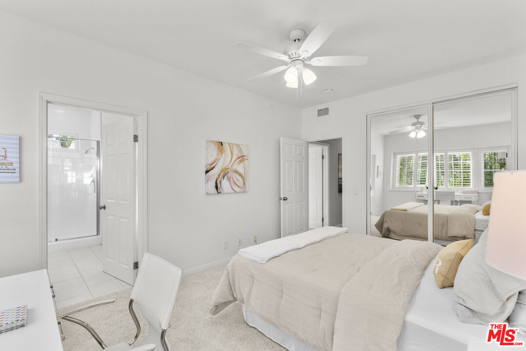 18779 Willowtree Lane Porter Ranch, CA 91326 - Photo 47 of 63 a bedroom with a large bed and a chandelier