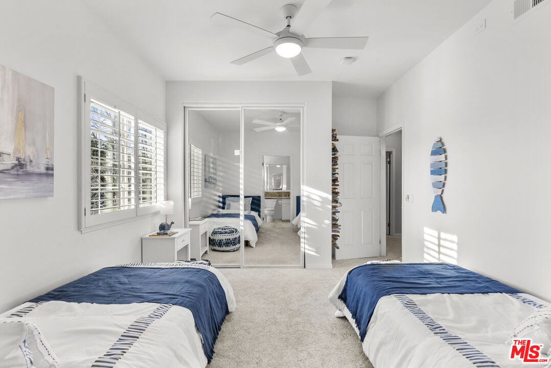 18779 Willowtree Lane Porter Ranch, CA 91326 - Photo 50 of 63 a spacious bedroom with a bed a couch and a large window
