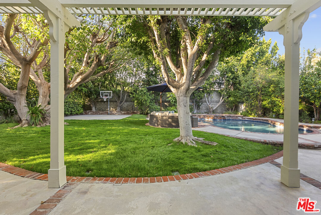 18779 Willowtree Lane Porter Ranch, CA 91326 - Photo 51 of 63 a view of a garden with a tree in the background