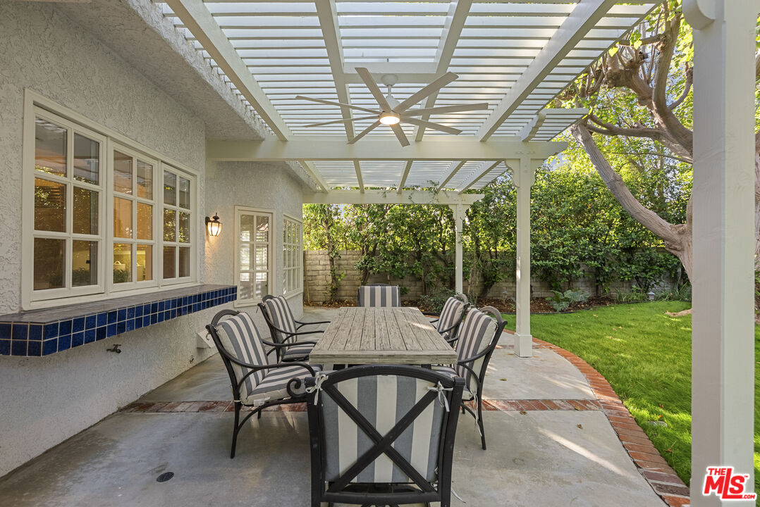 18779 Willowtree Lane Porter Ranch, CA 91326 - Photo 52 of 63 a view of a patio with a table chairs and a backyard