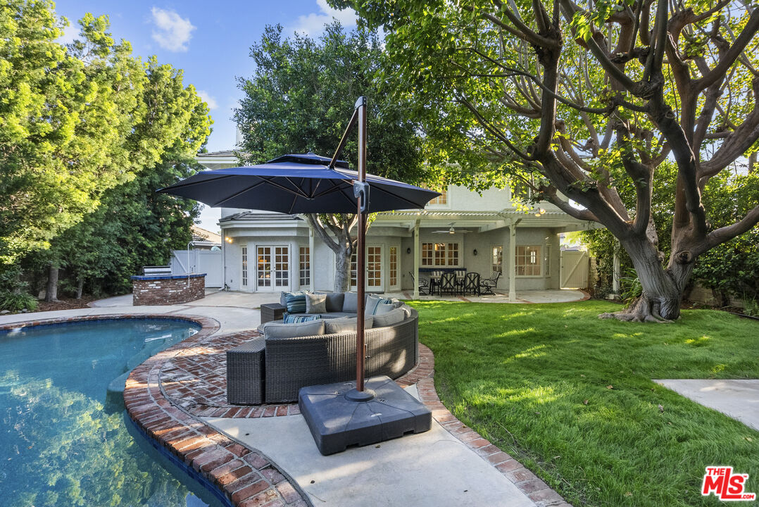 18779 Willowtree Lane Porter Ranch, CA 91326 - Photo 58 of 63 a view of a house with backyard sitting area and garden