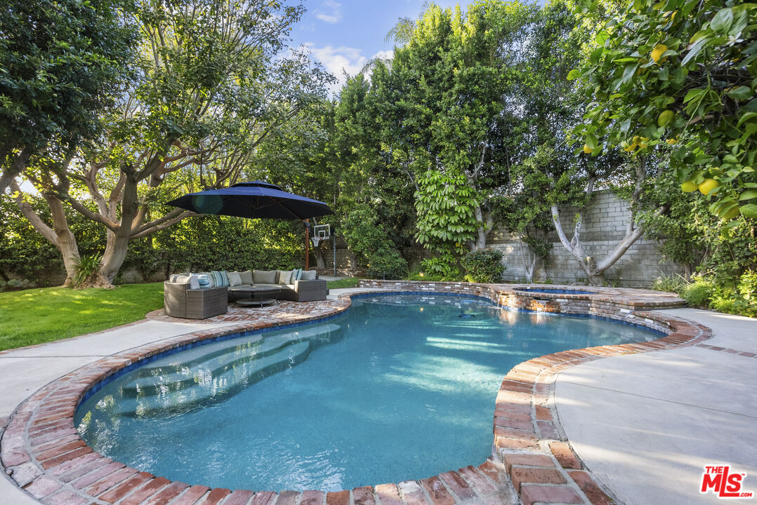 18779 Willowtree Lane Porter Ranch, CA 91326 - Photo 60 of 63 a view of a swimming pool with a sitting space