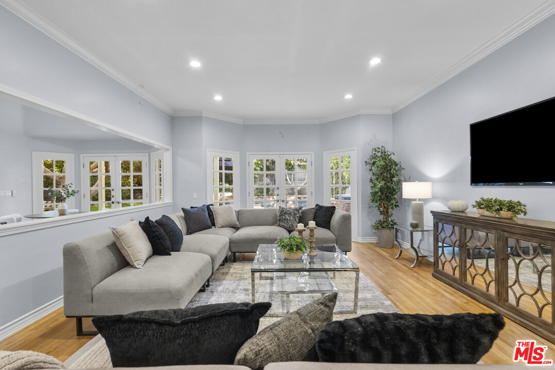 18779 Willowtree Lane Porter Ranch, CA 91326 - Photo 6 of 63 a living room with furniture and a flat screen tv