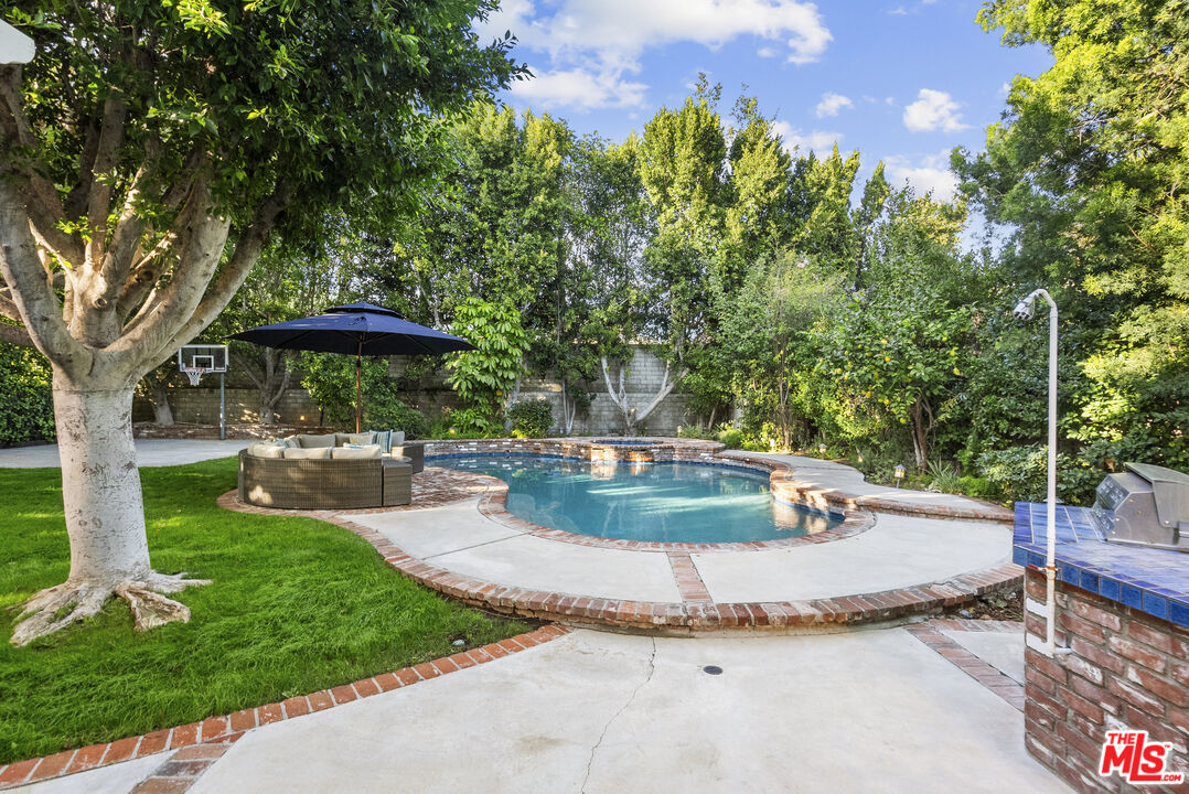 18779 Willowtree Lane Porter Ranch, CA 91326 - Photo 61 of 63 a view of a garden with a patio